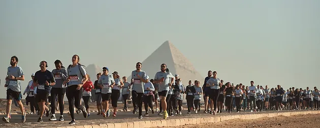 People Running behind the Pyramids