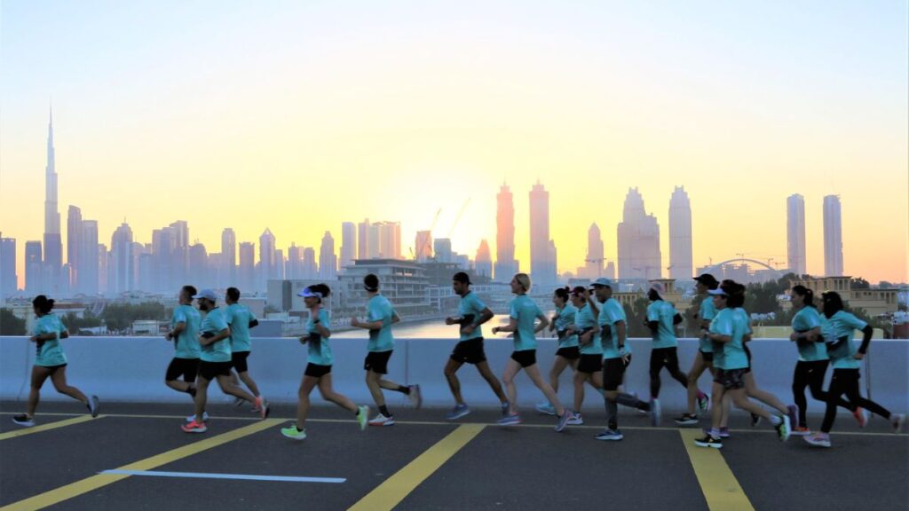 Participants running at the marathon with the amazing scenery of Dubai 