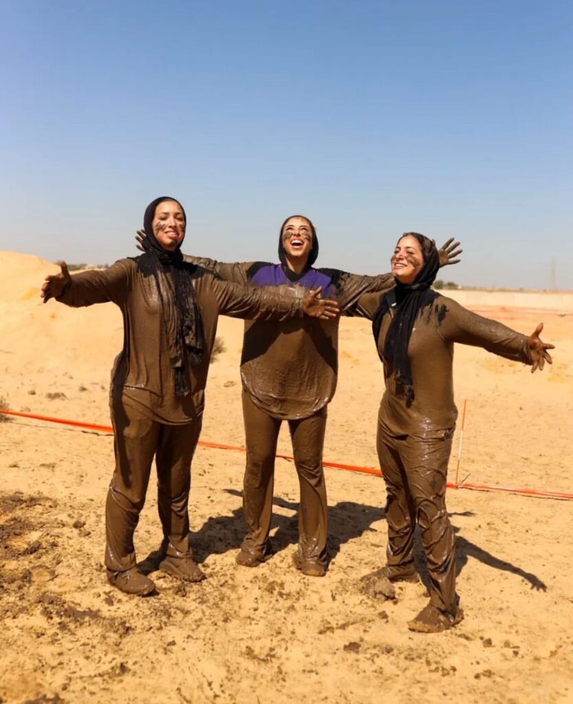 Three girls covered in mud and having fun in the event