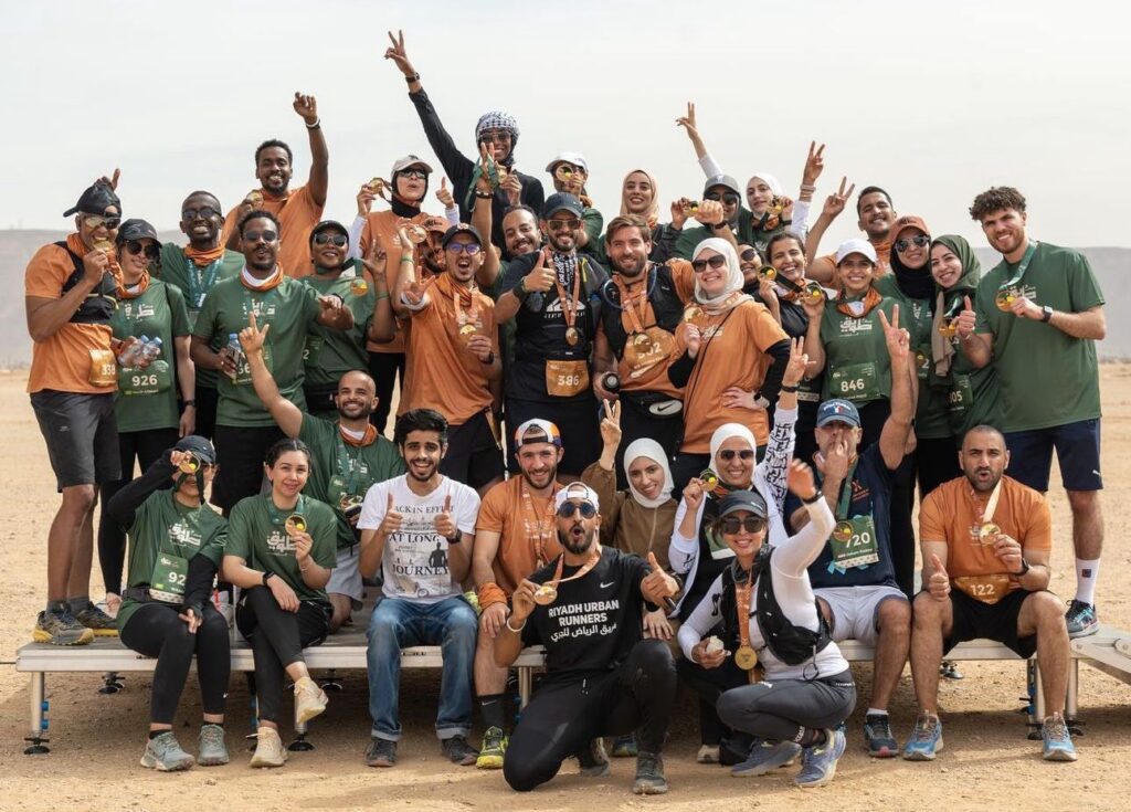 Group of finishers and organizers of race arabia posing with there tawiq trail race medals