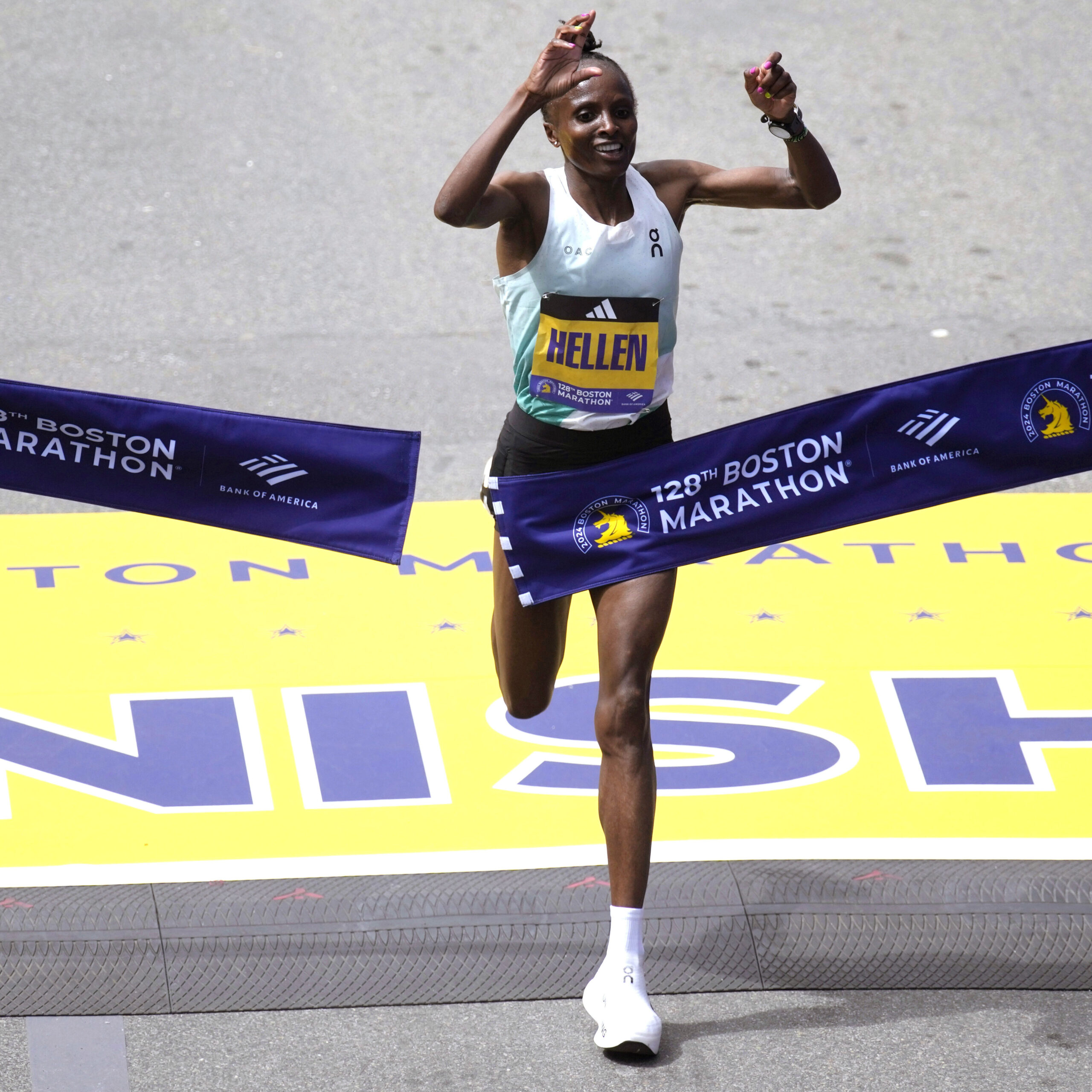 Hellen Obiri, of Kenya, raises her arms as she wins the women's division at the Boston Marathon, Monday, April 15, 2024, in Boston.